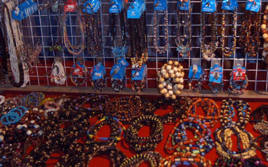 Servicemembers load up on trinkets and jewelry like these pieces for sale at a market outside the Ambassador City Hotel near Pattaya, where Gobra Gold is headquartered.