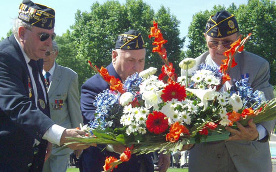 Members of American Legion Post No. 5 lay a wreath as part of a Memorial Day ceremony Sunday at the Rhone American Cemetery in Draguignan, France. The remains of 861 Americans killed in World War II are buried at the cemetery 60 miles west of Nice.