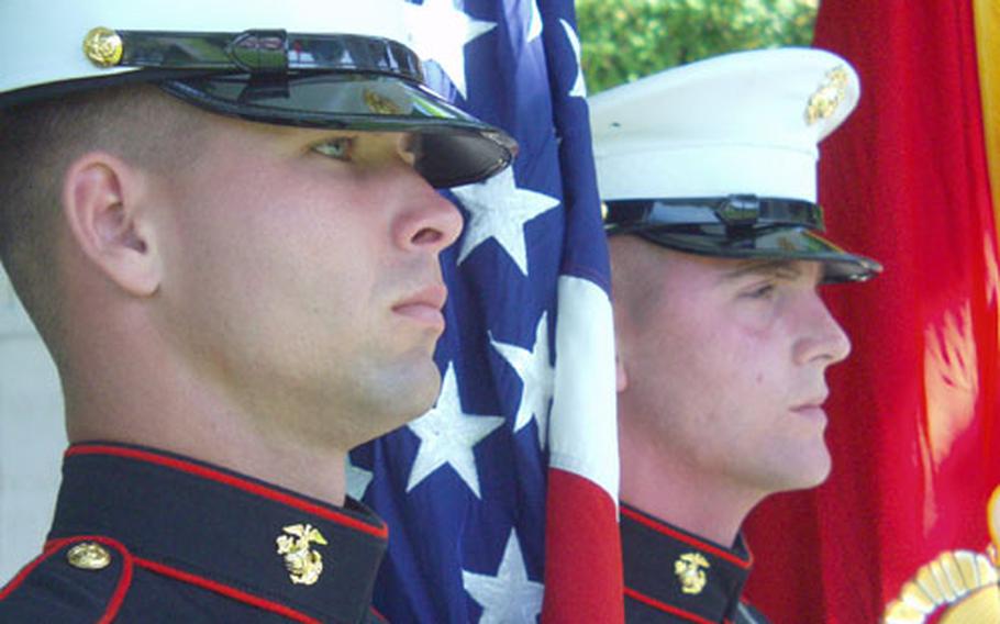 Marine Cpl. Henry Phillips, left, and Marine Sgt. Dustin Green, both stationed at Naval Station Rota, Spain, stand as part of the honor guard at a Memorial Day ceremony Sunday at the Rhone American Cemetery in Draguignan, France.