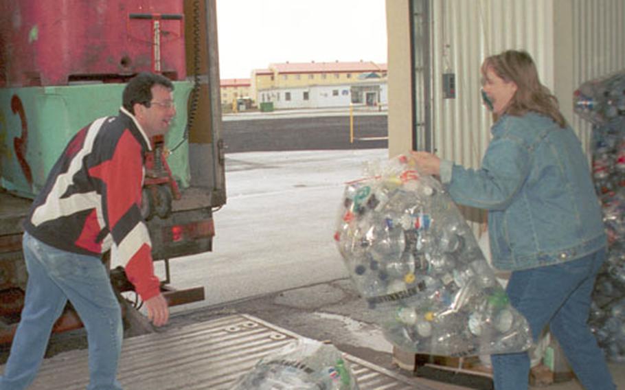 Manuel Eutrambasaguas, left, a recycling technician at the Recycling Center and his co-worker, Michelle Buchanan, the center’s recycling supervisor, load up a truck with cans and bottles collected from the previous week. A truck comes every Tuesday morning from the Endurvinnslan recycling plant in Reykjavík to pick up the items.