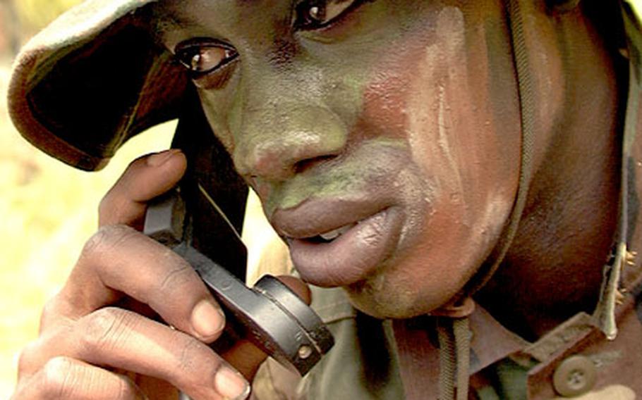 Marine Lance Cpl. Sharnell Carter listens in on a radio call during a break in recent training at Okinawa&#39;s Camp Hansen.