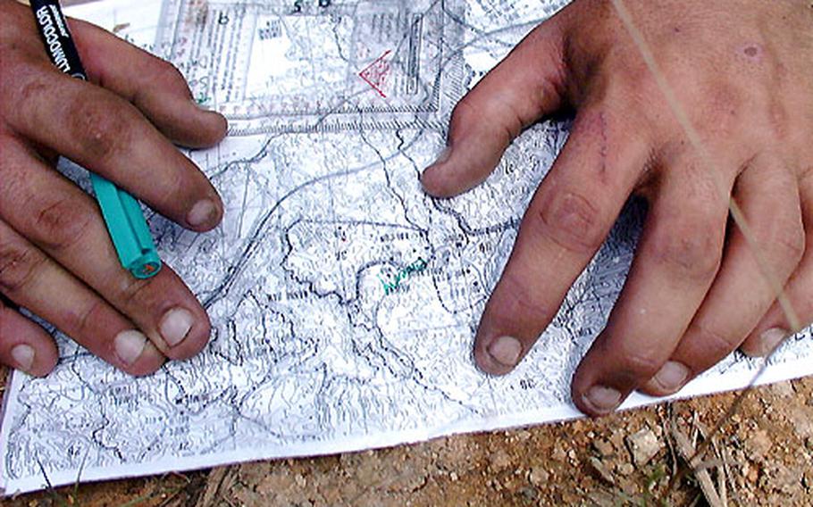 Map sheets and alcohol pens park the route toward enemy contact.