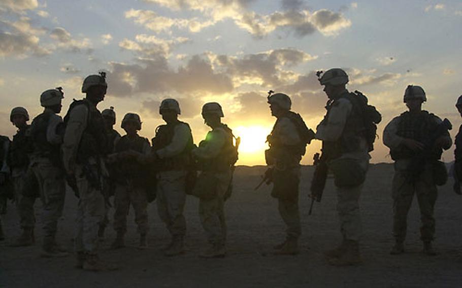 Troops from Company B, 1st Battalion, 15th Infantry assemble during the march north to Baghdad on March 23.