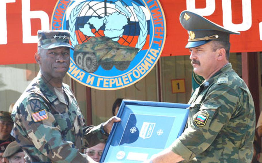 Lt. Gen. William Ward, left, commander of Stabilization Force, gives an SFOR plaque to Col. Sergey Mikhailovich Shakurin, commander of the last Russian Military Contingent rotation in Bosnia. A departure ceremony Wednesday concluded seven years of Russian participation in peacekeeping in Bosnia. Stabilization Force has already put a plan in place to cover the former Russian area of responsibility.