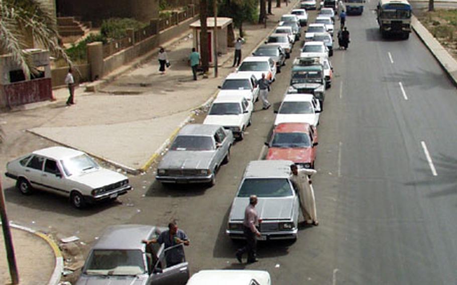 Cars line up for miles to get cheap gasoline at a station in Mansur. Those who don&#39;t want to wait for the limited supply pay five times the price on the black market.