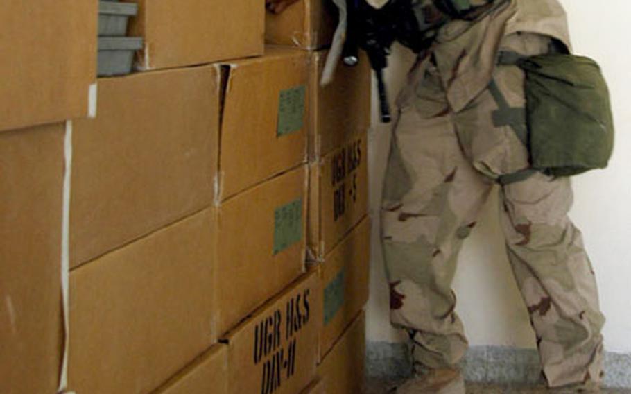 Spc. Luis Jau, of the 10th Mountain Division&#39;s 2nd Battalion, 14th Infantry Regiment from Fort Drum, N.Y., stacks the last box of food in a room at the Khatuzeen Center for Social Action in Irbil, Iraq.