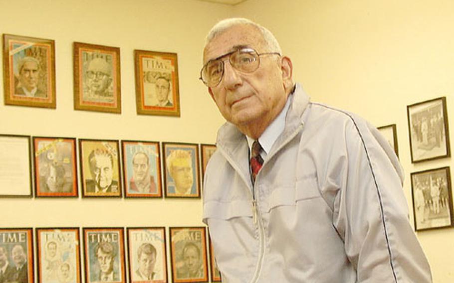 Educator Greg Apkarian says the autographed Time magazine front covers of famous people serve as a wall of history in his Okinawa office.