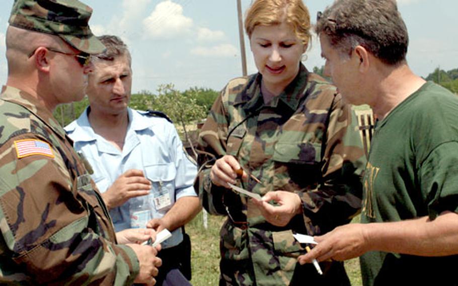 From left, Staff Sgt. Jeffery Rowell of Troop B, 1st Squadron, 167th Cavalry Regiment, Dragan Gluhovic, a police officer from Brcko District and interpreter Jovana Mijatovic explain to resident Marko Mendes how the raffle tickets work. Mendes turned in a hand grenade not knowing that he would receive tickets for a raffle.