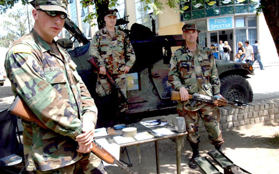 From left, Pfc. James Slagle, Spc. William Regan and Sgt. Robert McMullen, all of Troop B, 1st Squadron, 167th Cavalry Regiment, show off the weapons turned in at their collection point in Brcko.