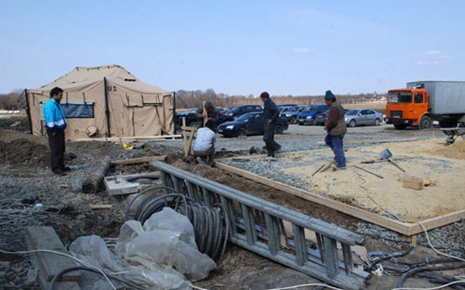 Workers upgrading a base in Constanta, Romania, used by U.S. Air Force troops for an air bridge bringing supplies and personnel to support Operation Iraqi Freedom.