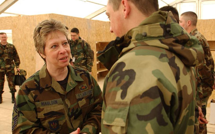 Chief Master Sgt. Vickie Mauldin, command chief master sergeant of U.S. Air Forces in Europe, chats with an airman in Constanta, Romania. Mauldin and USAFE commander Gen. Gregory S. Martin visited troops at eight forward bases in April.