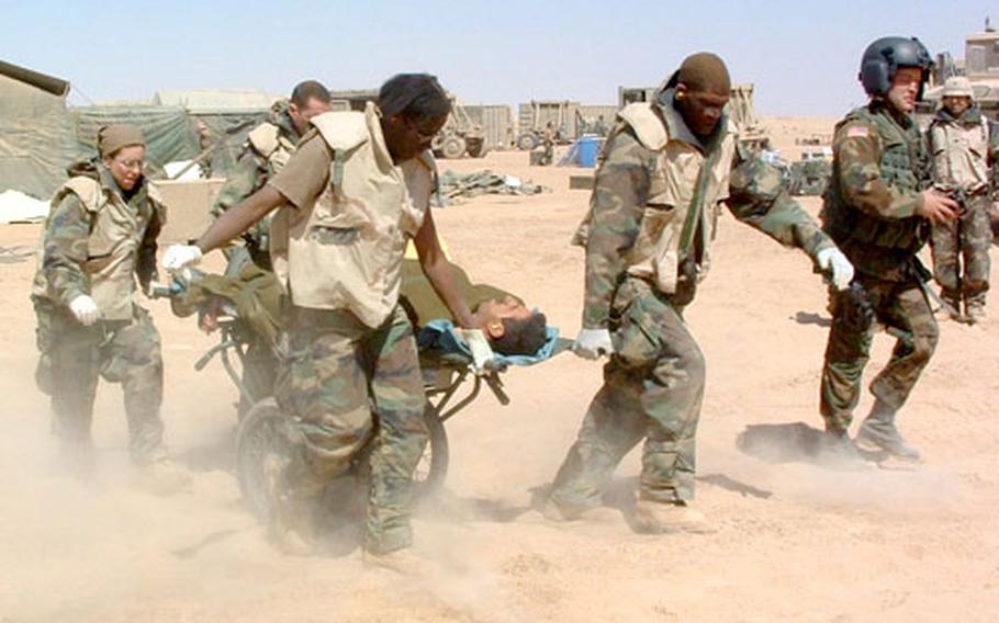 While evacuating a patient, Maj. Rhona Newsome and Capt. Joe Wilson anchor the front of the litter, while Capt. Alina Prieres and an unidentified officer take the rear. All are nurses.