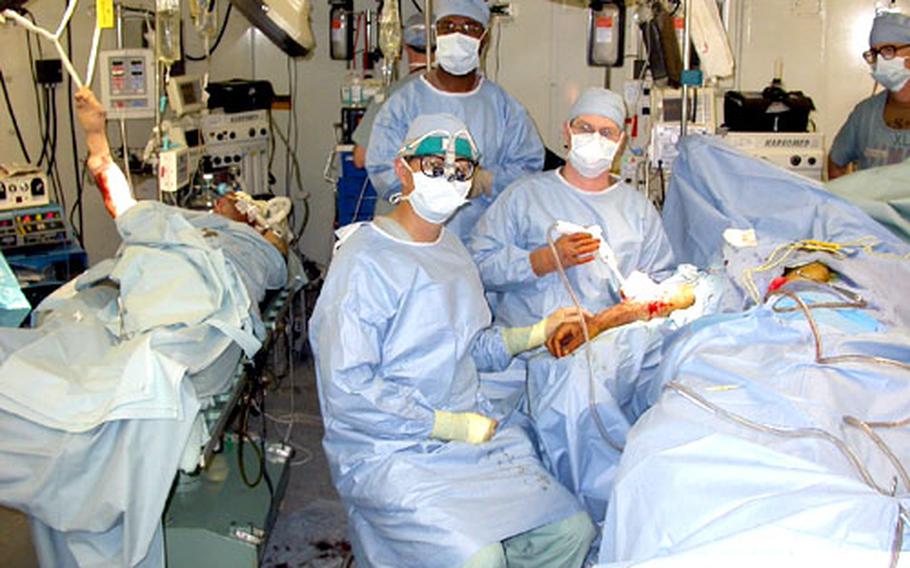 Both of the MASH&#39;s operating tables were busy about half the time. In front, Lt. Col. John Cho, a cardiothorasic surgeon, is joined by Lt. Col. Todd Morton, right, who is both a general and a plastic surgeon. Staff Sgt. Reginald Moise, in the background at center, is the 212th&#39;s operating room noncommissioned officer in charge.