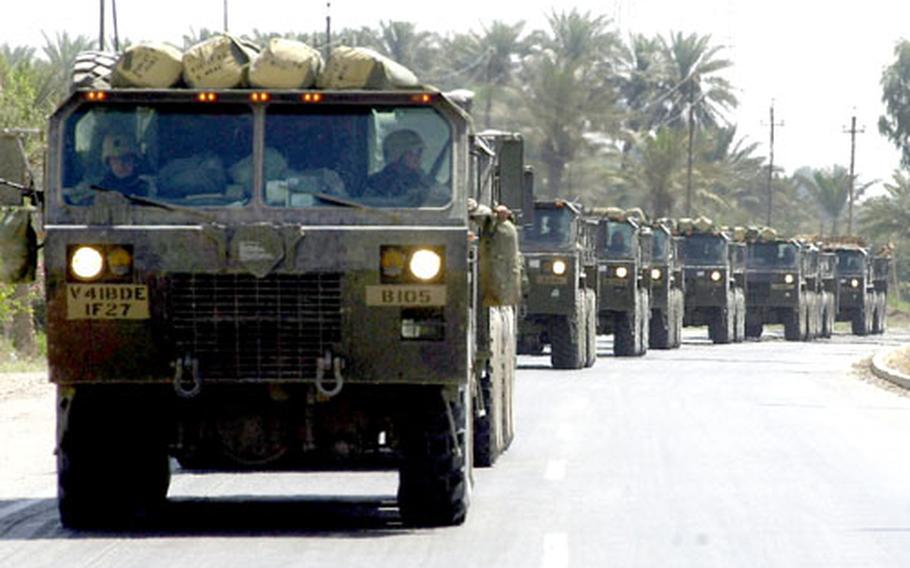 Heavy Expanded Mobility Tactical Trucks, or HEMTTs, of the Babenhausen-based 41st Field Artillery Brigade convoy out of Baghdad on their way to Red Rocket, a quarry where Iraqi munitions are held before being destroyed.