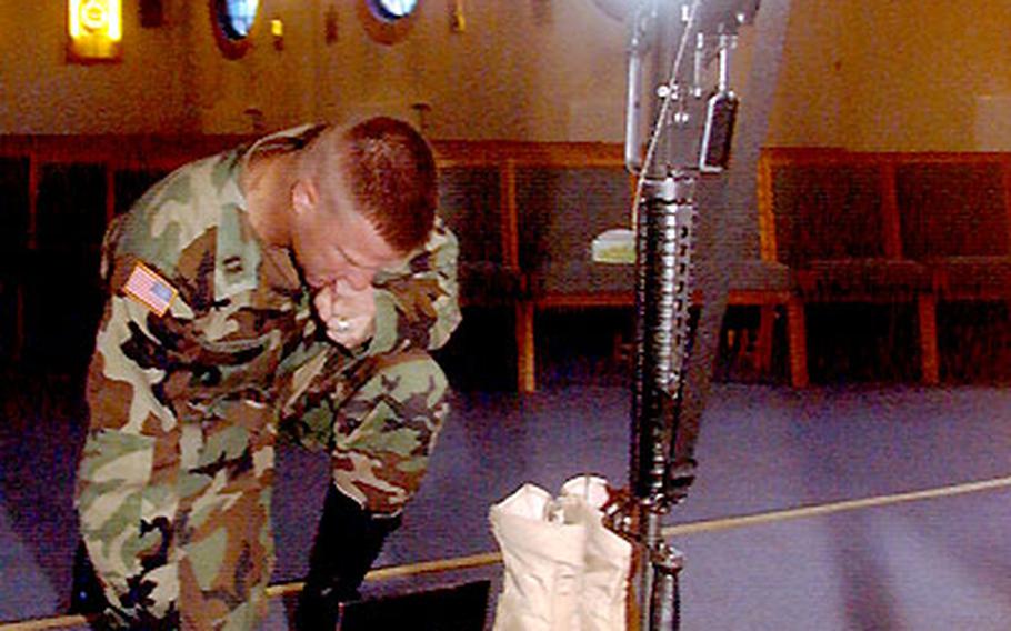 Capt. William Fitzhugh, one of Sgt. David B. Parson’s former commanders, pays a silent tribute to the 1st Battalion, 37th Armor Regiment soldier Wednesday in Friedberg, Germany.