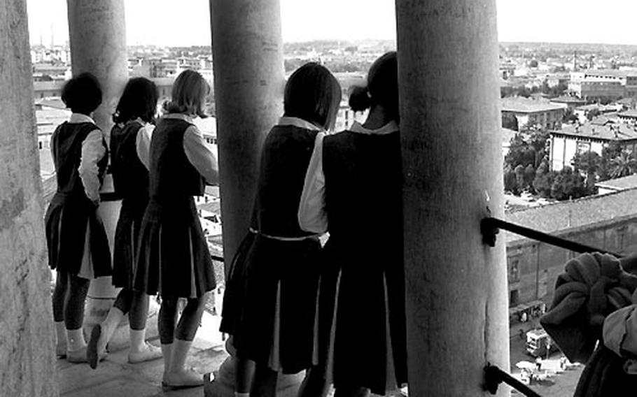 From their off-kilter viewpoint, the cheerleaders loom out at Pisa.