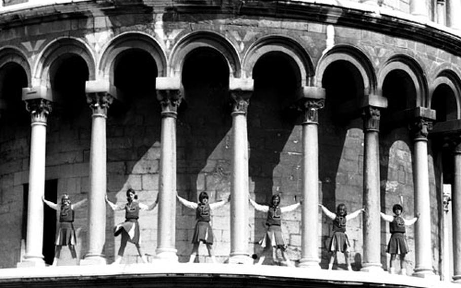 Cheerleaders Lynn Iannacio, Marny Rawson, Betsy Billington, Stephanie Hoare, Patty Butler and Cathy Rawson pose on the Leaning Tower of Pisa.