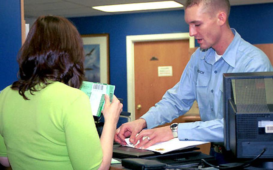 Seaman Christopher Jessich, a postal clerk, helps a customer mail her letter.