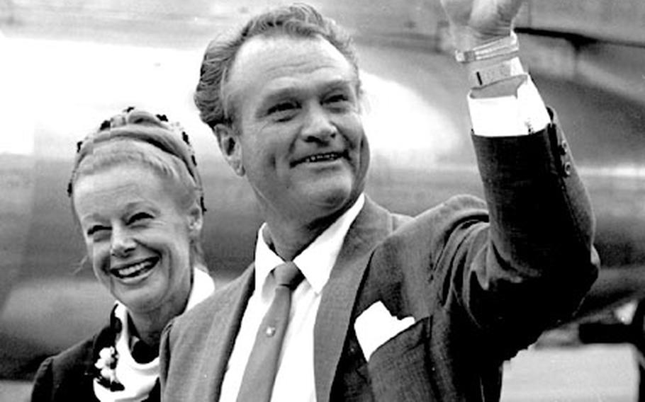 Comedian Red Skelton waves as he and his wife, Georgia, arrive in Tokyo in July, 1963.