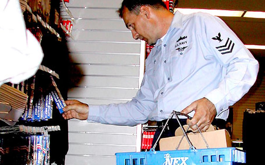 Chief Petty Officer(Select) Karl King takes a looks at a Chief Petty Officer uniform belt at Yokosuka&#39;s uniform shop. King is a Machinist Mate on the USS Kitty Hawk.