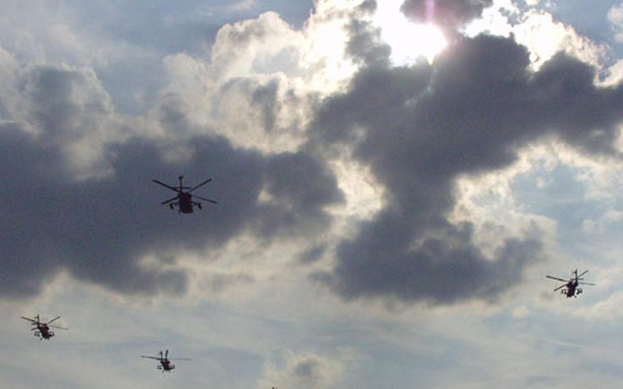 AH-64 Apache pilots from Charlie Company of the 1st Battalion, 1st Aviation Regiment fly a missing man formation upon their return last month to their base in Katterbach, Germany, after serving a tour in Kosovo. They flew the special formation in memory of two pilots, Chief Warrant Officer 3 Andrew Robbins and Warrant Officer Devon DeSouza, who died in a training crash in Koso on June 8.