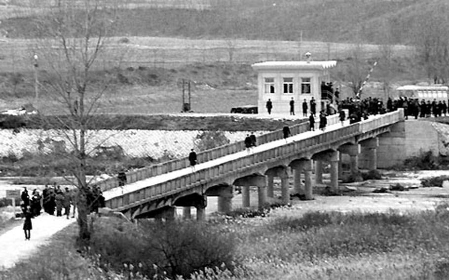 USS Pueblo crew members cross the bridge from North Korea at Panmunjom after their release on December 23, 1968.