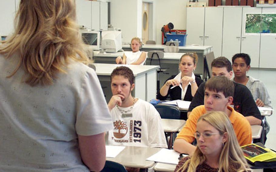 Laura Corder-Chavez talks to students enrolled in her physics class at Aviano High School in Italy.