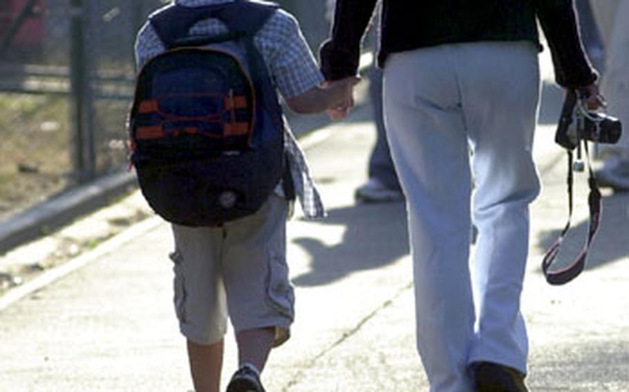 A mother and son walk to school on the first day of school year at Rhein-Main.
