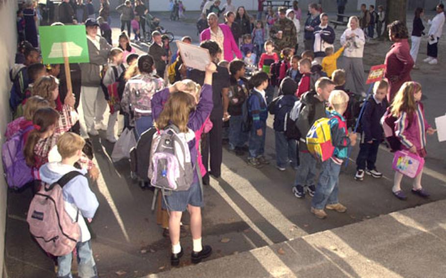 First- to third-graders line up outside on the first day of the new school year at Rhein-Main.