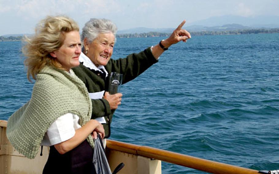Chiemsee tour guide Ann-Marie Dalngl shows a point of interest to her friend, Naval Reserve Cmdr. Anne Mitchell, Tuesday as the farewell boat cruise returns to Chiemsee’s Lake Hotel. Dalngl worked for 38 years at the resort.