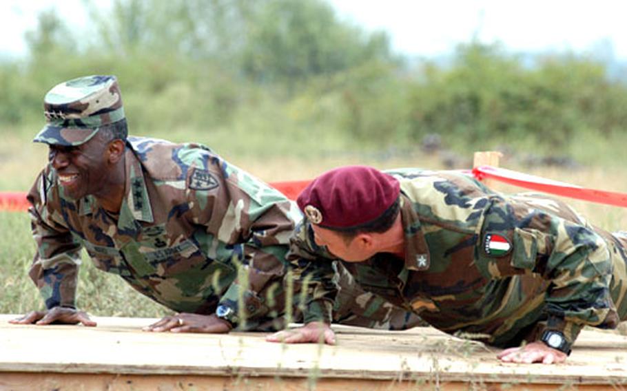 U.S. Lt. Gen. William Ward, the commander of the Stabilization Force, left, invited Italian Army Warrant Officer Massimo Di Prospero to do some push-ups together after giving him a coin for being flexible and responding well when things did not go right. Di Prospero’s parachute did not open properly Tuesday during a jump during Dynamic Response 03 exercise near Eagle Base. He deployed his auxiliary parachute and landed safely.