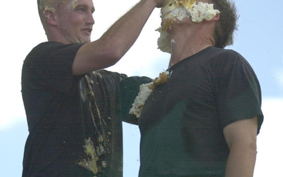 Senior Airman Doug Flowers, 18th Logistics Readiness Squadron, smears a whipped cream pie in the face of the 18th Wing Commander, Brig. Gen. Jeffrey Remington. The two were the top vote-getters in the pie-in-the-face fundraiser for the Air Force Ball with 196 votes each. Flowers paid $205, $100 which was his own and the rest donated, to have the honor of smearing the pie in Remington&#39;s face.