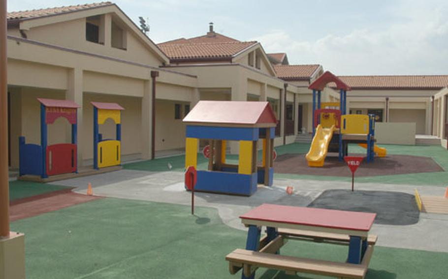 A playground in the center of the Sigonella kindergarten building depicts a city street scene, complete with buildings, street signs and roads.
