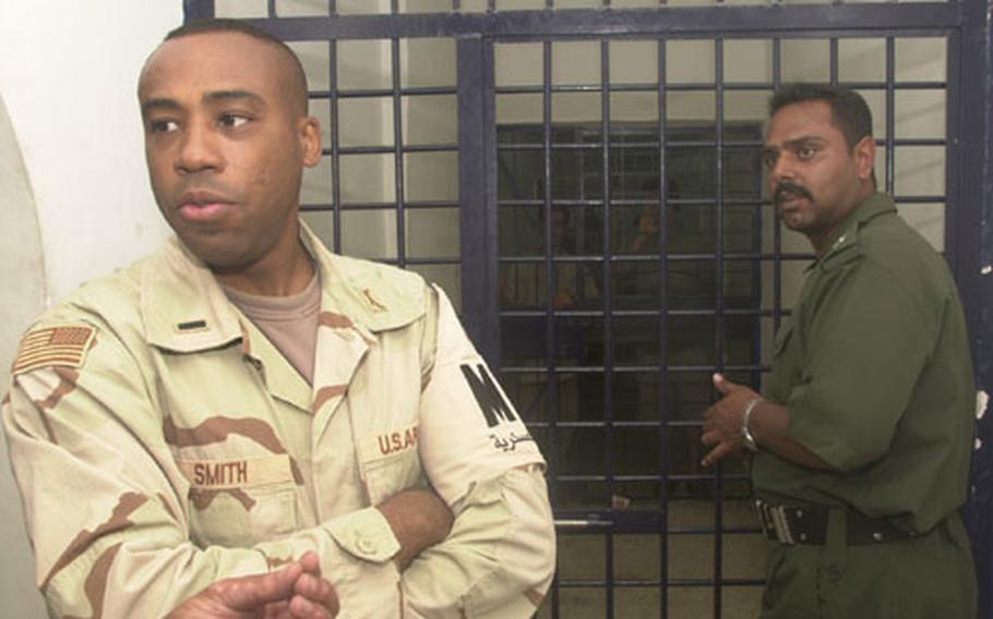 1st Lt. Kevin Smith describes himself as "hard, but fair." A different personality than his elder brother, Herbert, Kevin Smith says he sees himself remaining in the military for 30 years. Here he confers with Iraqi police in front of abu Deshear police station’s holding cells.