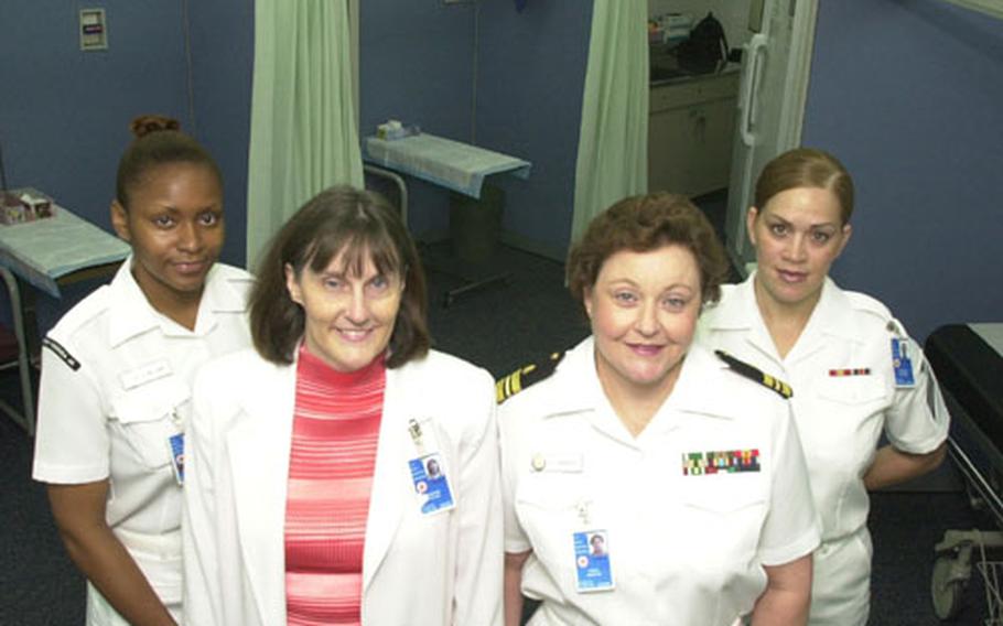 Left to right, Corpsman Ester Williams, Nurse Theresa Fulton, Lt. Cdr. Carol Haddock and Corpsman Michelle Ellwood stand in the Yokosuka Navalk Hospital pediatrics examination room, which recently received a face-lift.