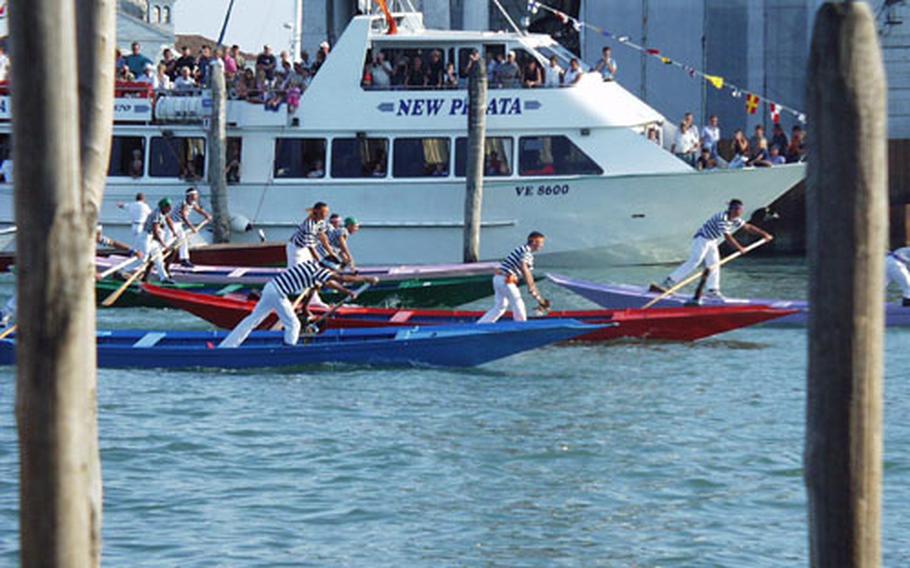 The field is packed as it enters the narrow part of the Grand Canal during the first race of the Regata Storica in Venice, Italy, on Sunday. Following a parade-like exhibition by participants, some dressed in colorful costumes, there were four races held for gondolas in different categories.