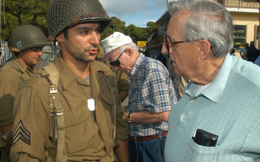 Joseph Heiser, right, chats with an Italian re-enactor on the 60th anniversary of Heiser&#39;s landing at Paestum, Italy, on Sept. 9, 1943, with the 36th Infantry Division&#39;s 141st Regiment during World War II. In the background at center is J.W. Hawkins, who also made the landing with the division.