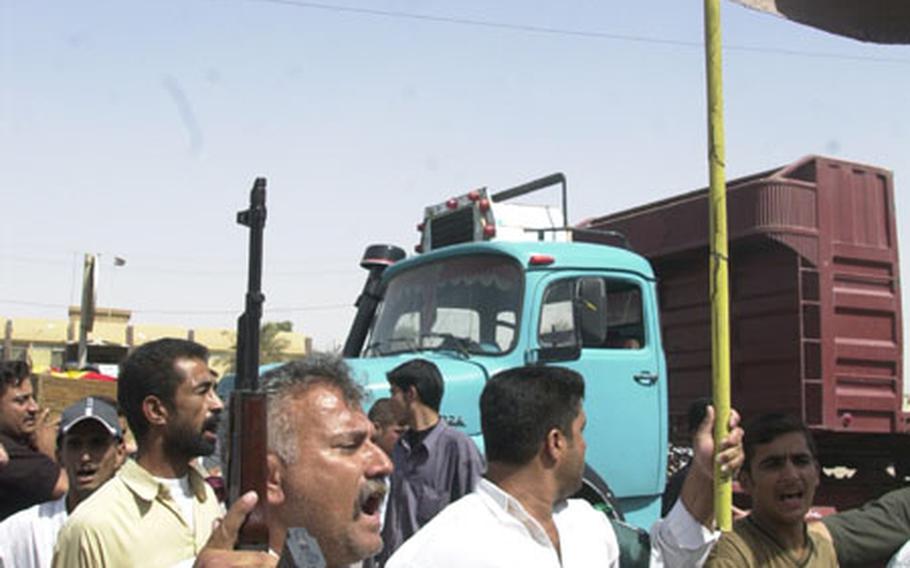 Angry Fallujah residents take to the streets for the funeral procession of the first of eight Iraqi Police officers killed Friday in an accidental shootout with American soldiers. Other than salutory gunfire and chants of "America is the enemy of Islam," the funeral procession was peaceful.