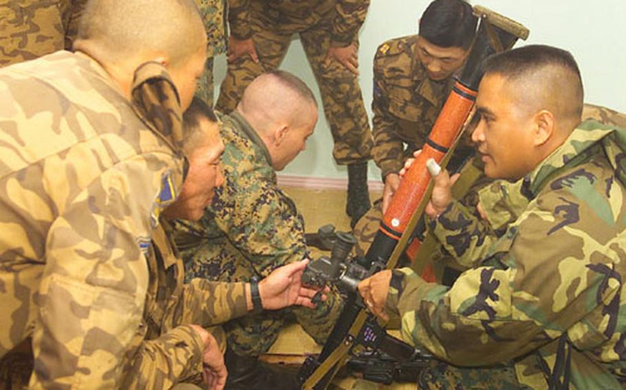 Staff Sgt. Reynante R. Bautista, staff non-commissioned officer takes a look at a Mongolian grenade launcher.