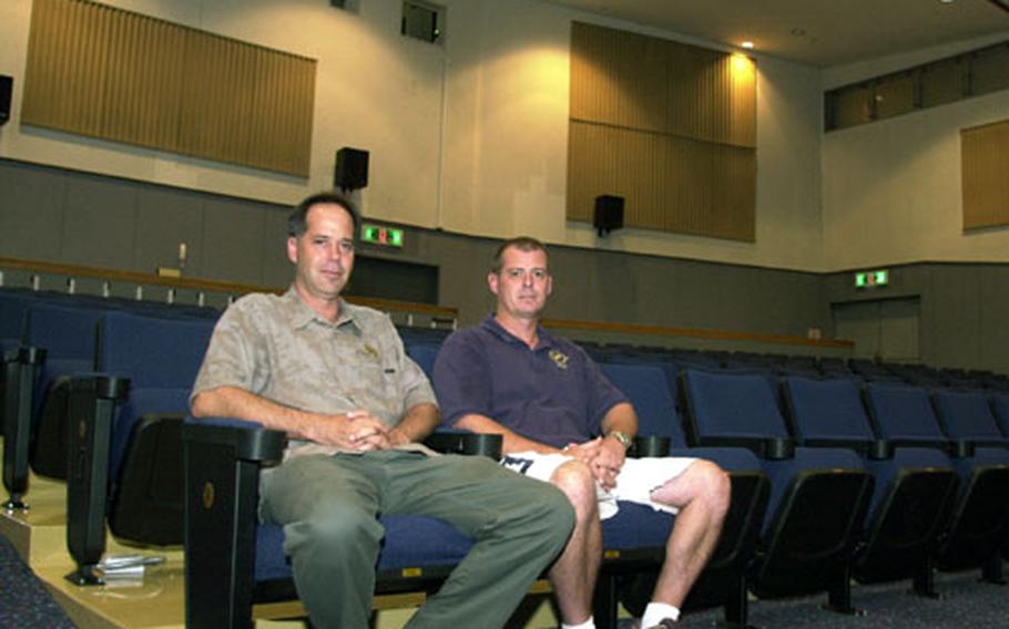 Navy Morale, Welfare and Recreation Entertainment Director Earl Murray, left, and Lead Projectionist Gregg Hooper sit in the newly renovated Fleet Theater at Yokosuka Naval Base, Japan.