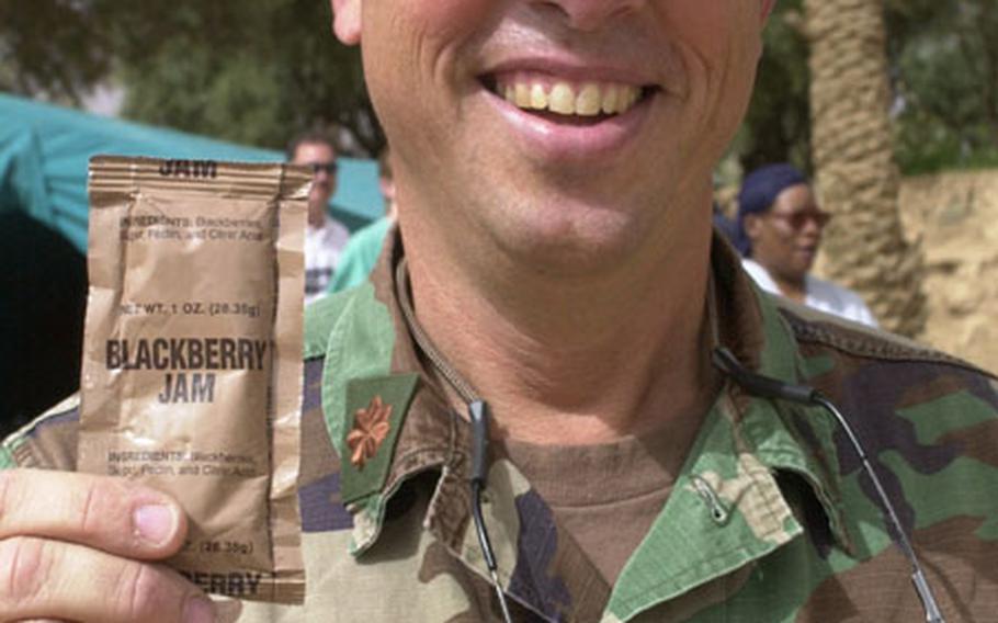 Lt. Cmdr. Tom Craig, an emergency room doctor based at Naval Station Rota, Spain, holds packet of blackberry jam from a Meals, Ready to Eat package. Craig used a similar packet of jam from his MRE to revive a Moroccan boy in hypoglycemic shock. (enw# 43p cs)