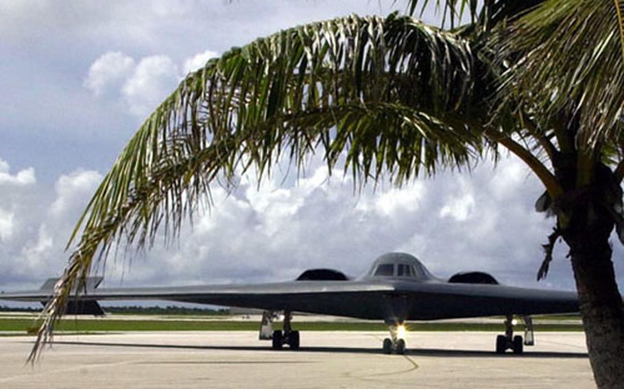 The B-2 Spirit of Kitty Hawk taxis into place on the palm tree-lined flightline at Andersen Air Force Base, Guam, Sept. 17 after an 18-hour flight from its home at Whiteman Air Force Base, Mo.