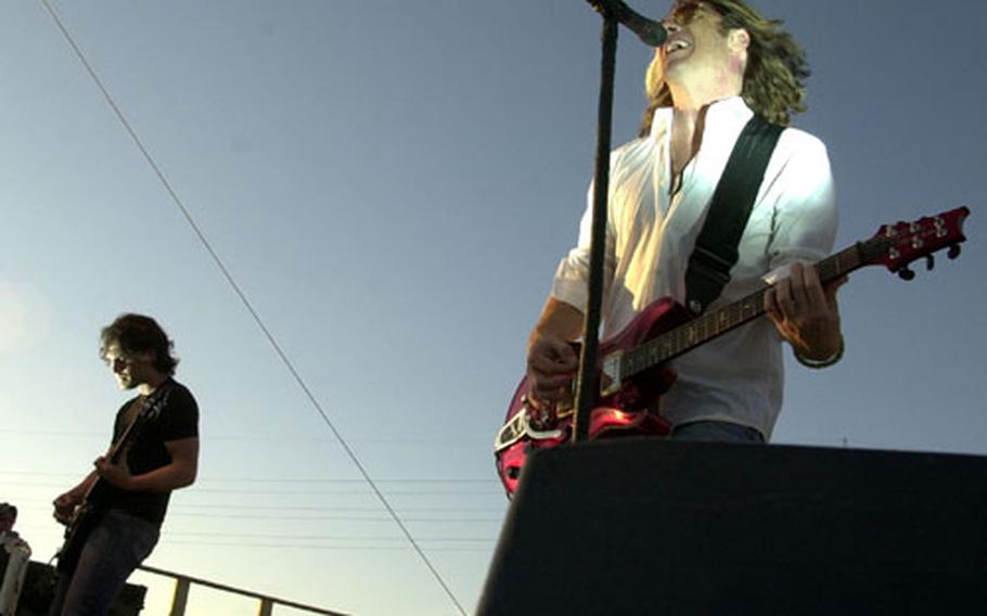 Collective Soul lead singer Ed Rowland, right, and lead guitarist Joel Kosch perform at Friday&#39;s 50th anniversary fiesta at Naval Station Rota in Spain. The concert also featured the Navy Sixth Fleet Band and Spanish flamenco dancers.