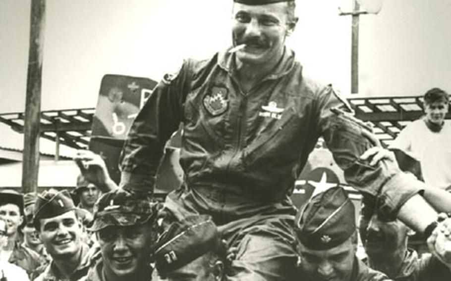 Wolf Pack pilots of the 8th Tactical Fighter Wing carry Col. Robin Olds, the 8th Tactical Fighter Wing commander, away from his F-4 Phantom on Sept. 23, 1967, as he returned from his 100th combat mission over North Vietnam. The four-time MiG killer, often termed "the hottest pilot in Southeast Asia," found a vast, emotion-filled crowd gathered to bid their chief farewell. The veteran pilot led the Wolf Pack to 24 MiG victories in one year, the greatest aerial-combat record for an F-4 wing in the Vietnam conflict.