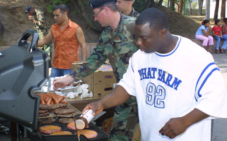 Army Sgt. Norm Izzard, in white cooking for the Kaiserslautern Middle School barbecue, is a well-known volunteer in the Kaiserslautern area. His official job is as the 415th BSB&#39;s installation coordinator.