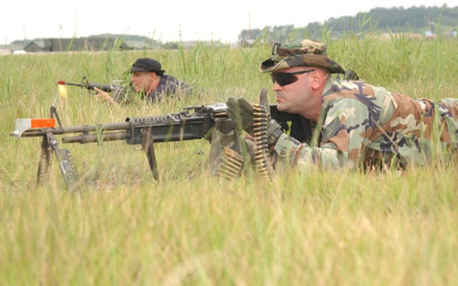 Staff Sgt. Jack Constable, foreground, and Tech. Sgt. Eric Kiefer act as opposition force members attacking the 8th Security Forces Squadron during a July exercise. Kunsan forces stage another exercise this week.