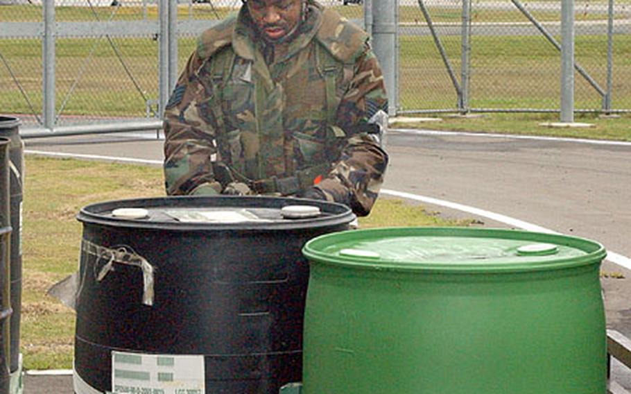 Staff Sgt. Chris Vincent, 35th Logistics Readiness Squadron, Misawa Air Base, Japan, secures barrels of Aqueous Film Forming Foam to be shipped to northern Japan for use in the event of an oil refinery fire.