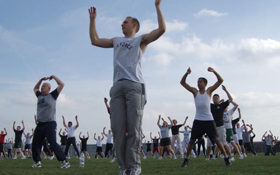 Members of 52nd Equipment Maintenance Squadron, Munitions flight, at Spangdhalem Air Base, Germany, begin their workout with jumping jacks.