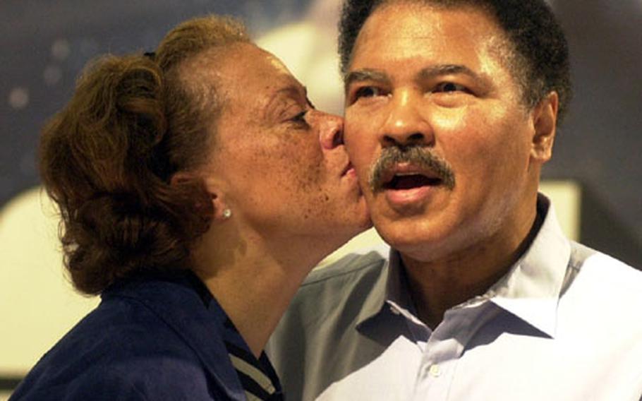 Muhammad Ali gets a peck on the cheek from wife Lonnie at the presentation of the new book "GOAT — A Tribute to Muhammad Ali" published by Taschen.