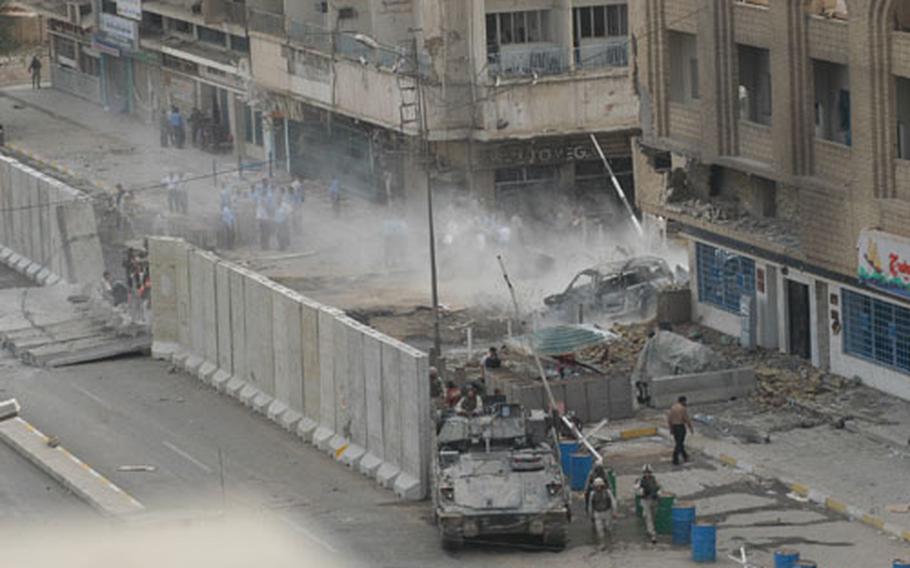 Dust rises from the scene of a car bombing near the Baghdad Hotel Sunday afternoon. Troops from the 1st Armored Division, 2nd Armored Cavalry Regiment and numerous military police companies had cordoned off the scene within a half hour of the blast.